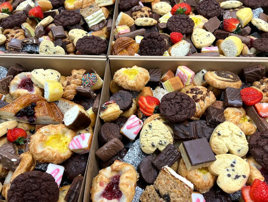 Cake boxes of muffins, danishes, brownies and cookies